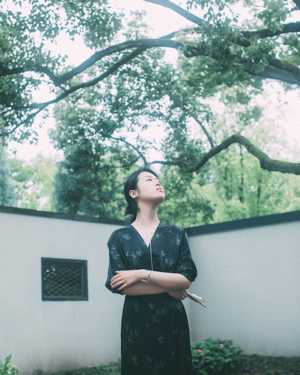 Person meditating peacefully in a minimalist environment with soft lighting.